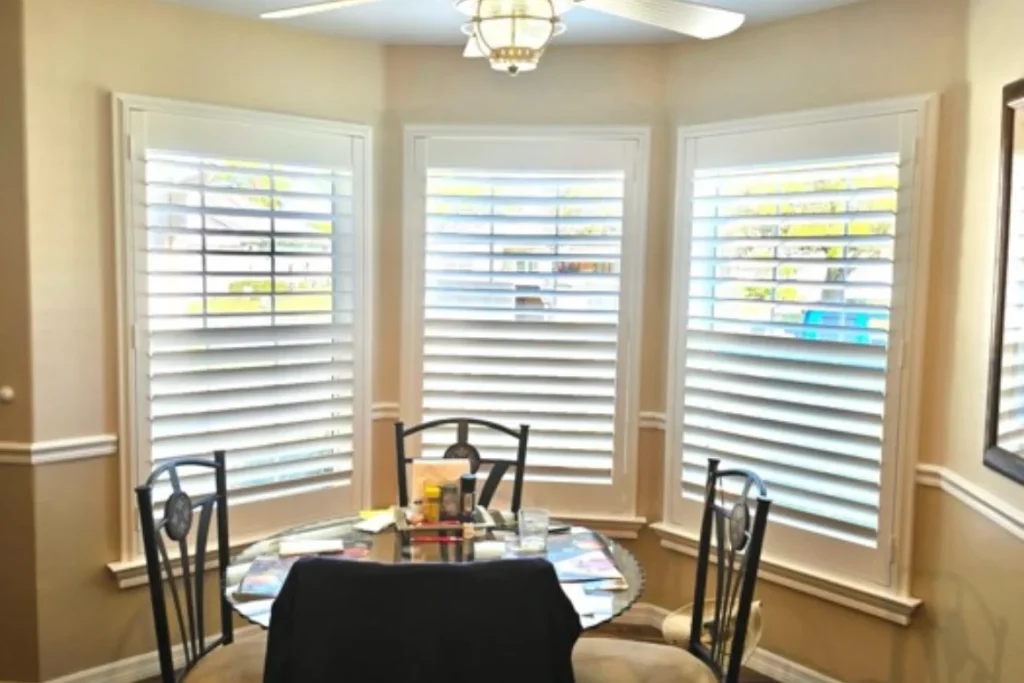 Custom plantation shutters on a dining room bay window in a Stone Crest home, Summerfield FL